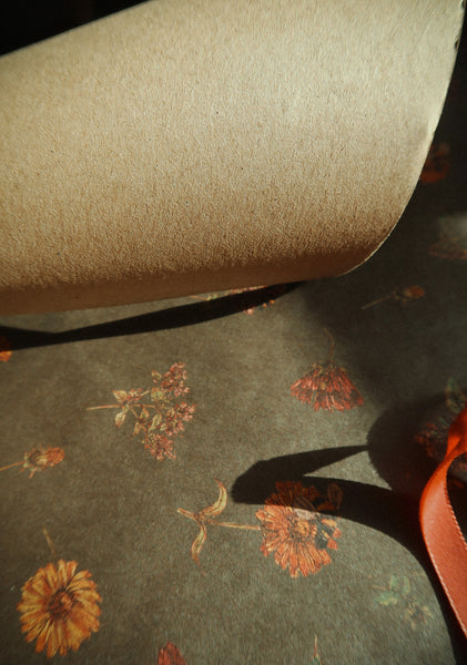 Florals on dark green kraft wrapping paper