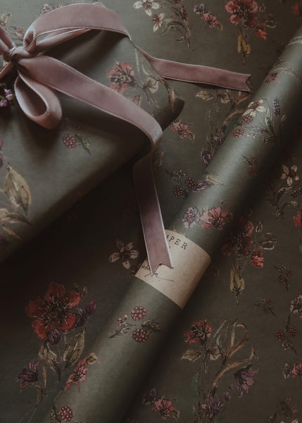 Floral-patterned gift wrap with a ribbon on a matching background