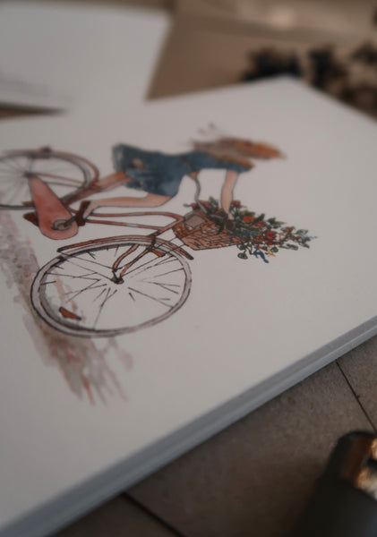 Girl on a bicycle / postcard